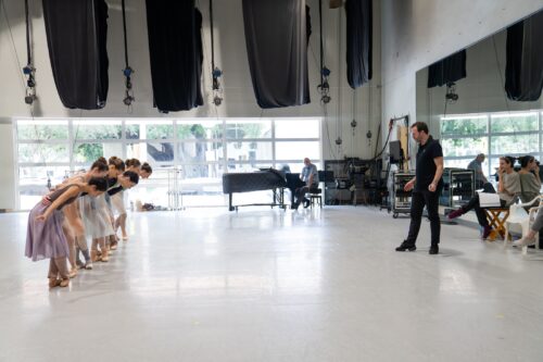 Alexei Ratmansky considers the ballerinas’ reverence to Strauss’s music during a rehearsal ofhis "Roses from the South, Three Waltzes for Toby." (Photo courtesy of Miami City Ballet)
